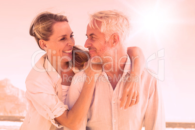 Attractive married couple hugging at the beach