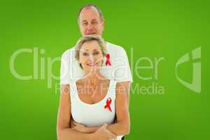 Composite image of mature couple supporting aids awareness toget