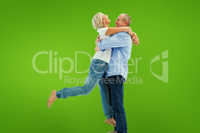 Composite image of mature couple hugging and having fun