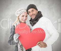 Composite image of smiling couple in winter fashion posing with