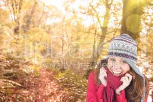 Composite image of cold redhead wearing coat and hat