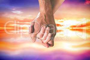 Composite image of happy senior couple holding hands