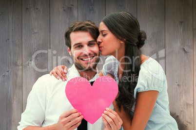 Composite image of pretty brunette giving boyfriend a kiss and h