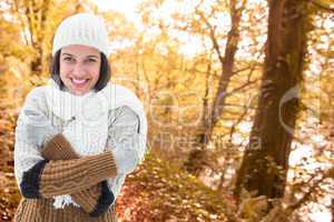 Composite image of brunette in warm clothing