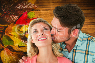 Composite image of handsome man kissing girlfriend on cheek