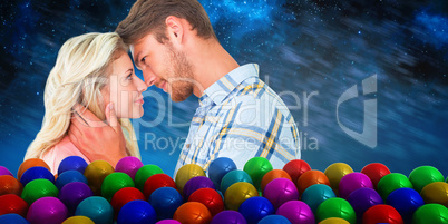 Composite image of attractive couple smiling at each other