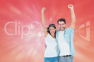 Composite image of happy casual couple cheering together