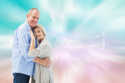 Composite image of happy mature couple hugging and smiling