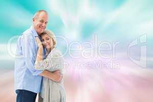 Composite image of happy mature couple hugging and smiling