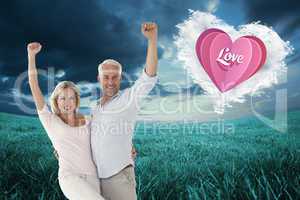 Composite image of smiling couple cheering at the camera