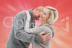 Composite image of happy mature couple in winter clothes