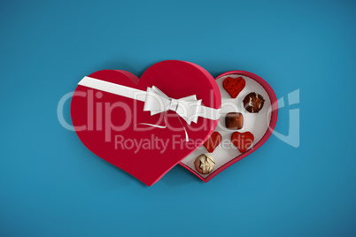 Composite image of heart shaped box of candy