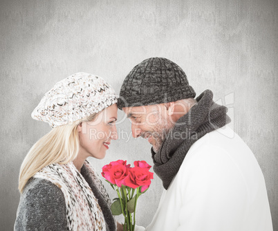 Composite image of smiling couple in winter fashion posing with