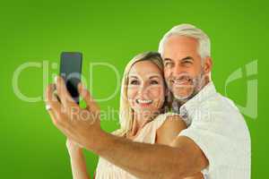 Composite image of happy couple posing for a selfie