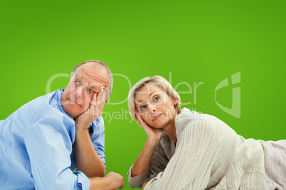 Composite image of mature couple lying and thinking