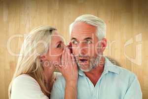 Composite image of woman whispering a secret to husband