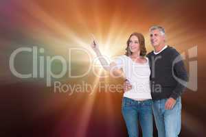 Composite image of casual couple walking and pointing