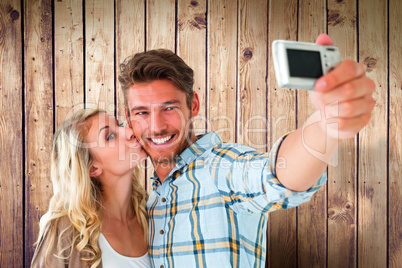 Composite image of attractive couple taking a selfie together