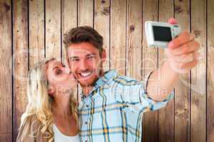 Composite image of attractive couple taking a selfie together