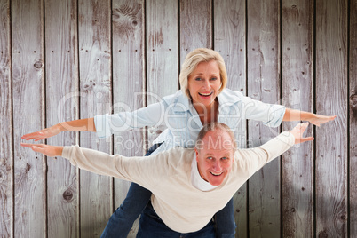 Composite image of happy mature couple having fun