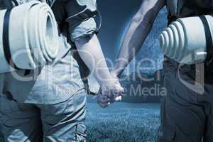 Composite image of hitch hiking couple standing holding hands on