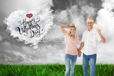 Composite image of happy couple walking holding hands