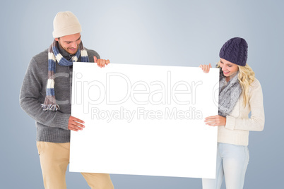 Composite image of attractive couple in winter fashion showing p