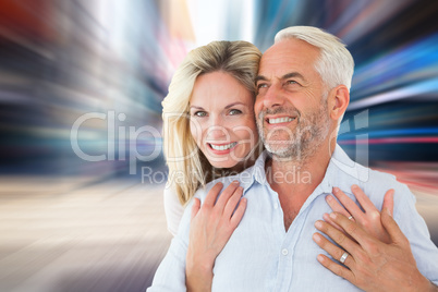 Composite image of smiling couple embracing with woman looking a