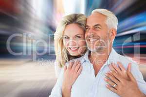 Composite image of smiling couple embracing with woman looking a