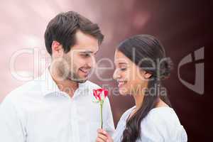 Composite image of handsome man offering his girlfriend a rose