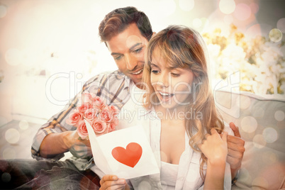 Loving couple with flowers and greeting card