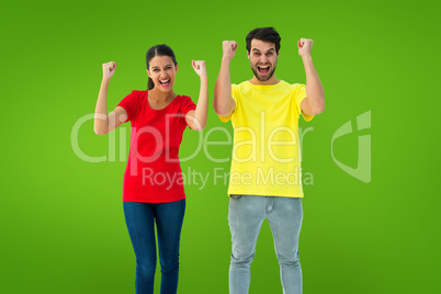 Composite image of excited couple cheering in red and yellow tsh