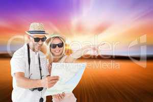 Composite image of happy tourist couple using map and pointing