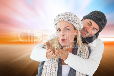 Composite image of smiling couple in winter fashion posing