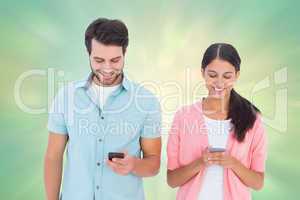 Composite image of happy couple sending text messages