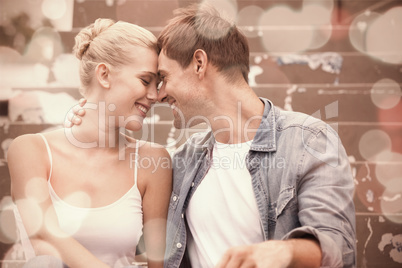 Hip young couple in denim sitting on steps