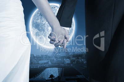 Composite image of close up of cute young newlyweds holding thei