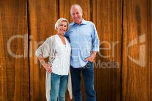 Composite image of happy mature couple hugging and smiling