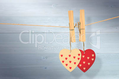 Composite image of hearts hanging on the line