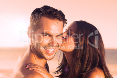 Attractive woman kissing her boyfriend on the cheek