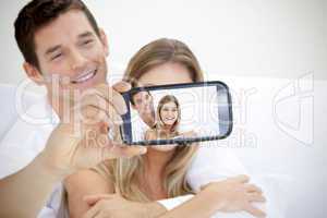 Couple taking selfie on smartphone