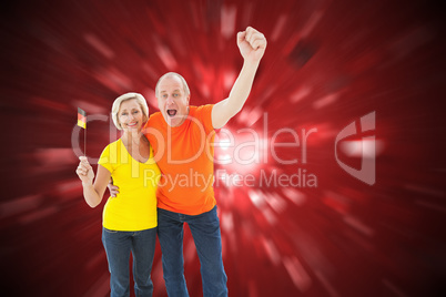 Composite image of happy german couple cheering at camera