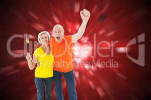 Composite image of happy german couple cheering at camera
