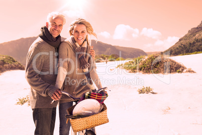 Carefree couple going on a bike ride and picnic on the beach