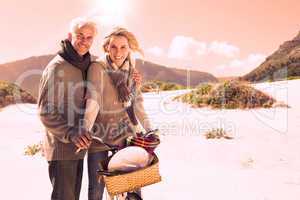 Carefree couple going on a bike ride and picnic on the beach