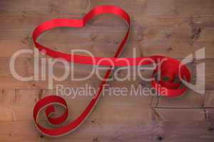 Large red ribbon in a heart shape