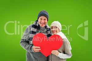 Composite image of happy mature couple in winter clothes holding