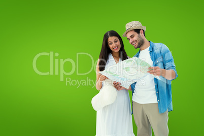 Composite image of happy hipster couple looking at map