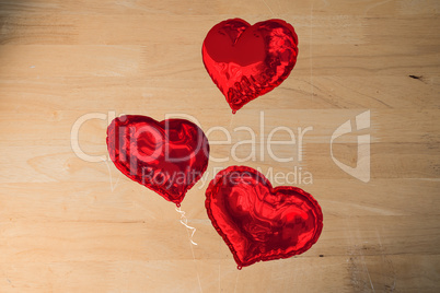 Composite image of love heart balloons