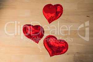 Composite image of love heart balloons